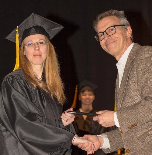 Christal being presented her HSE diploma by The Literacy Alliance’s Brian Schlichtenmyer