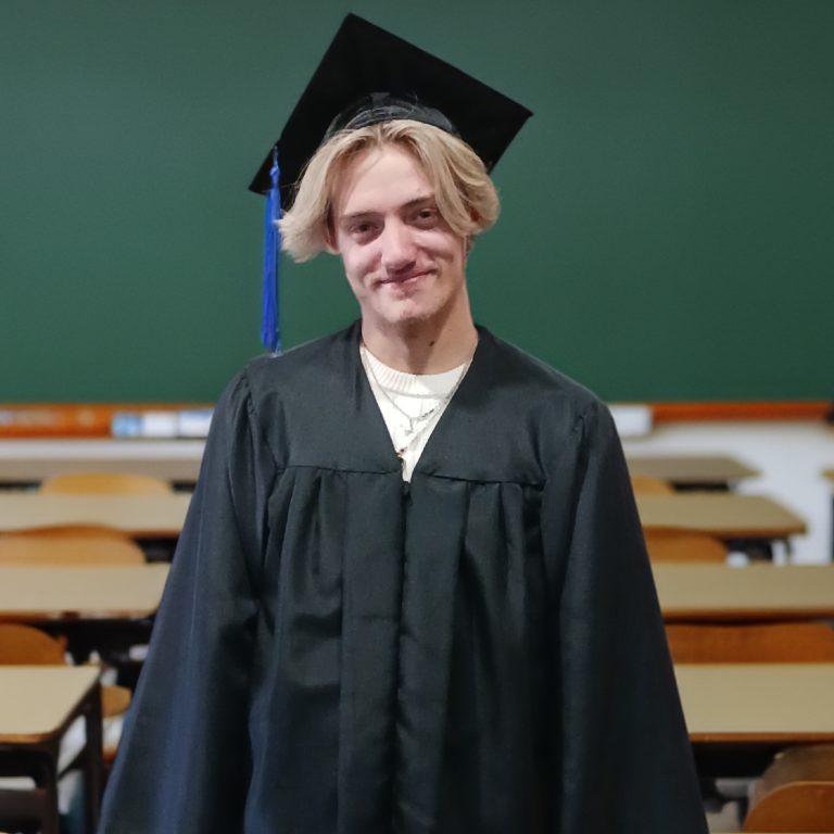 TLA Student Connor in graduation regalia.